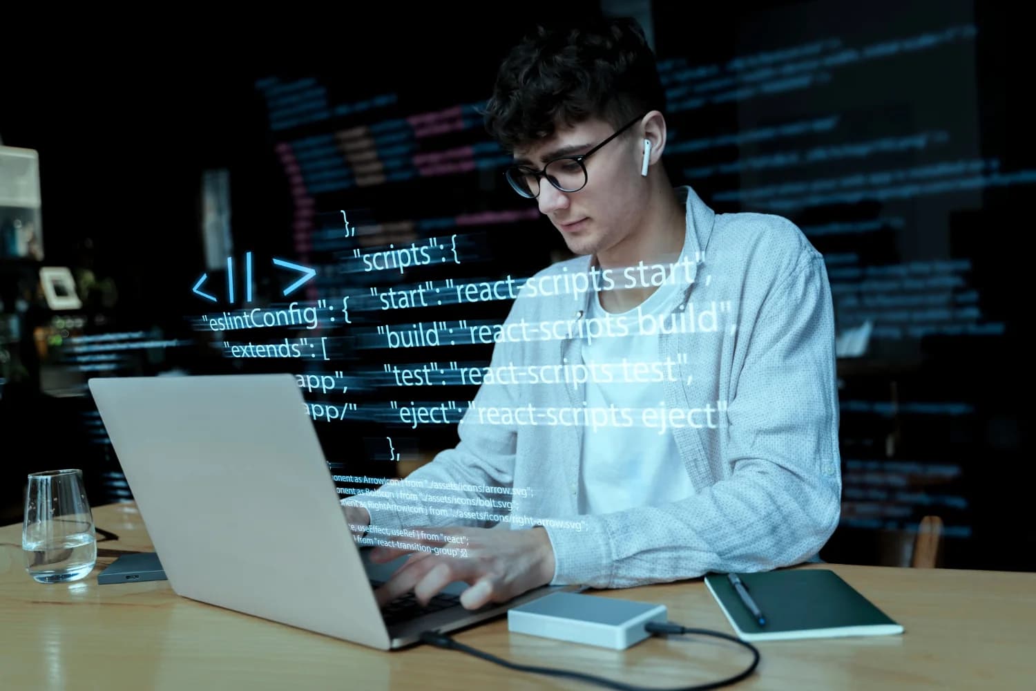 A TeamJUH engineer building a React application, with the project's code shown alongside.